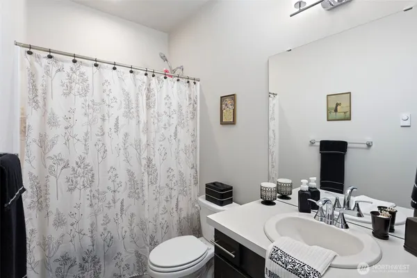 a bathroom with a sink toilet and mirror