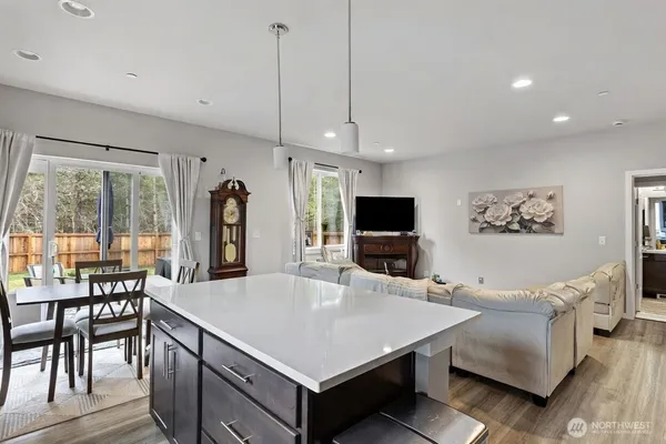 a living room with furniture a flat screen tv and a large window