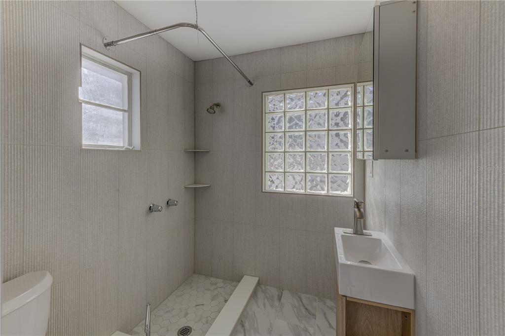 16245 Gulf Boulevard Redington Beach, FL 33708 - Photo 11 of 30 a bathroom with a sink a window and shower