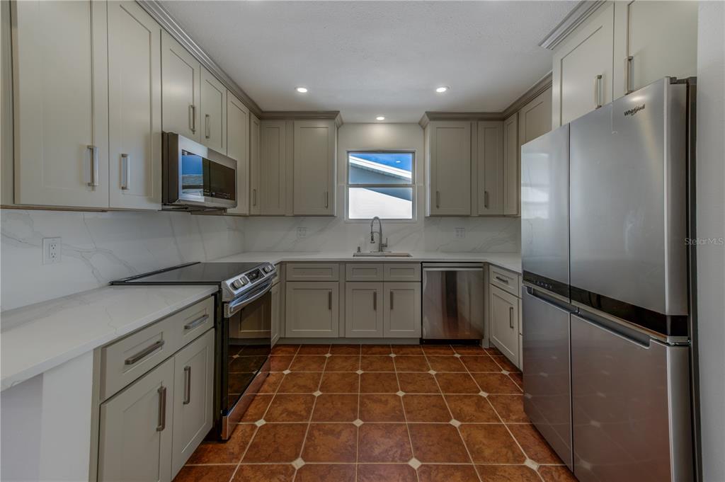 16245 Gulf Boulevard Redington Beach, FL 33708 - Photo 20 of 30 a kitchen with a sink a stove and refrigerator