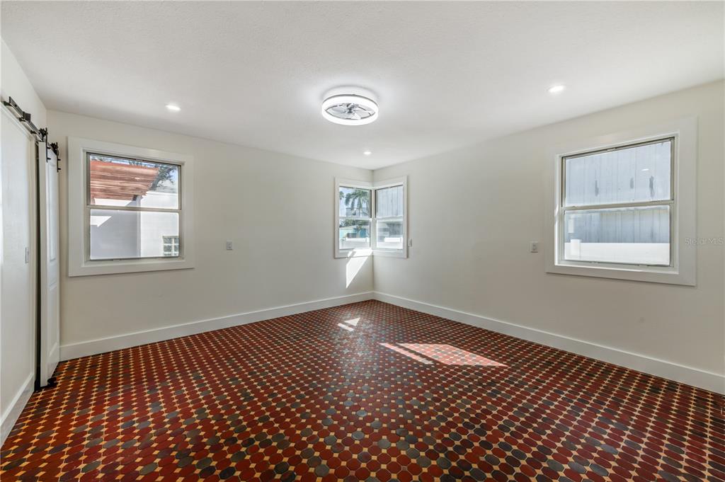 16245 Gulf Boulevard Redington Beach, FL 33708 - Photo 25 of 30 a view of an empty room with a window and wooden floor