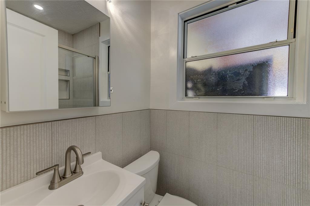 16245 Gulf Boulevard Redington Beach, FL 33708 - Photo 27 of 30 a bathroom with a toilet sink and mirror