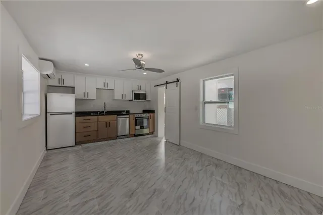 a bathroom with a sink a window and shower