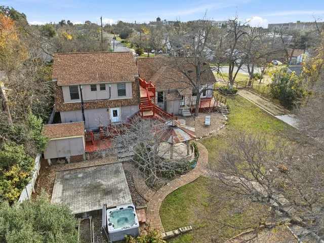 an aerial view of a house with a yard