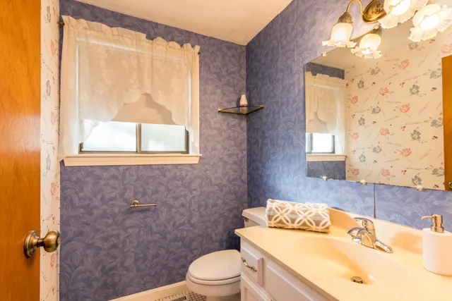 a living room with furniture a ceiling fan and a window