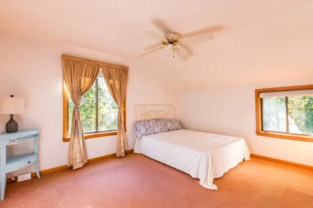a bathroom with a sink a toilet and a window