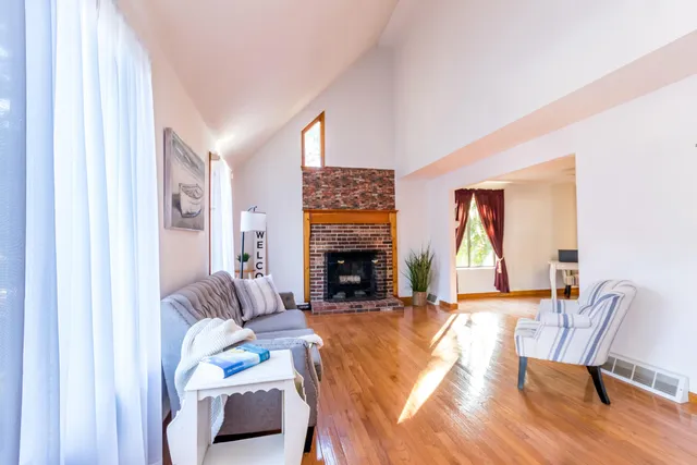 a living room with furniture and a fireplace