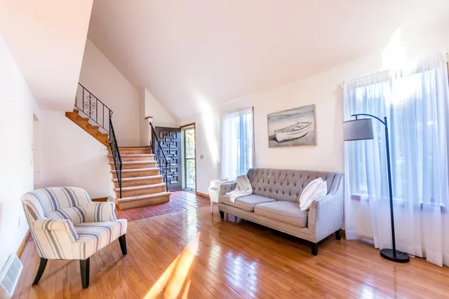 a living room with furniture and a wooden floor