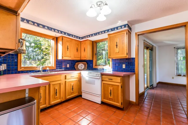 a kitchen that has a lot of cabinets in it and a window