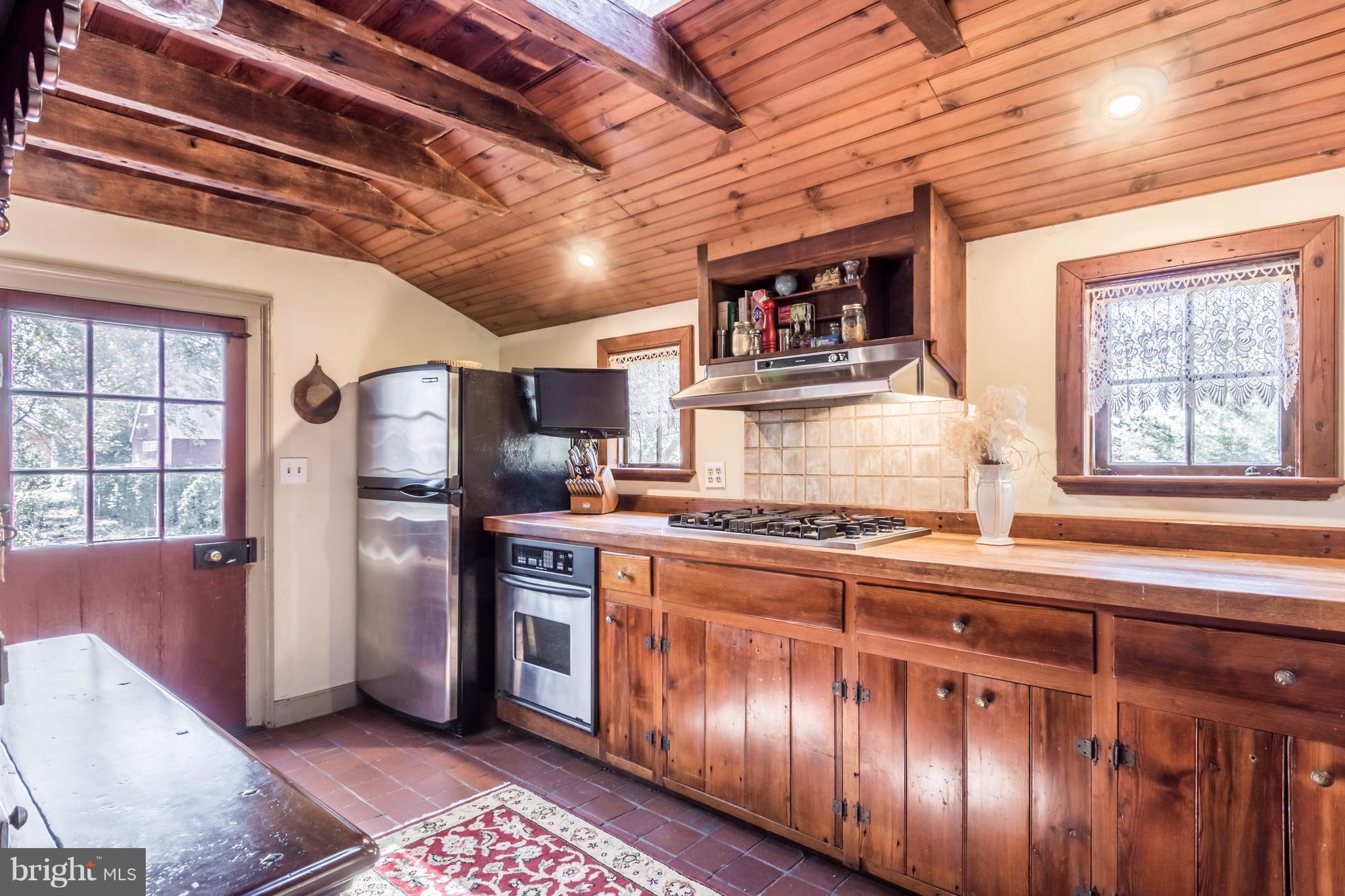 1625 Peters Corner Road Marydel, MD 21649 - Photo 12 of 30 a kitchen with refrigerator a stove a sink and cabinets