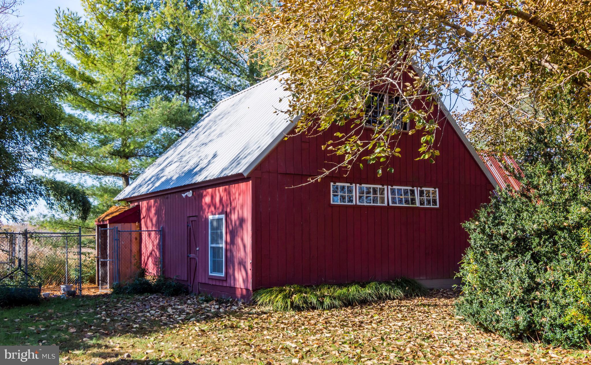 1625 Peters Corner Road Marydel, MD 21649 - Photo 28 of 30 a view of a back yard with red door and wooden fence