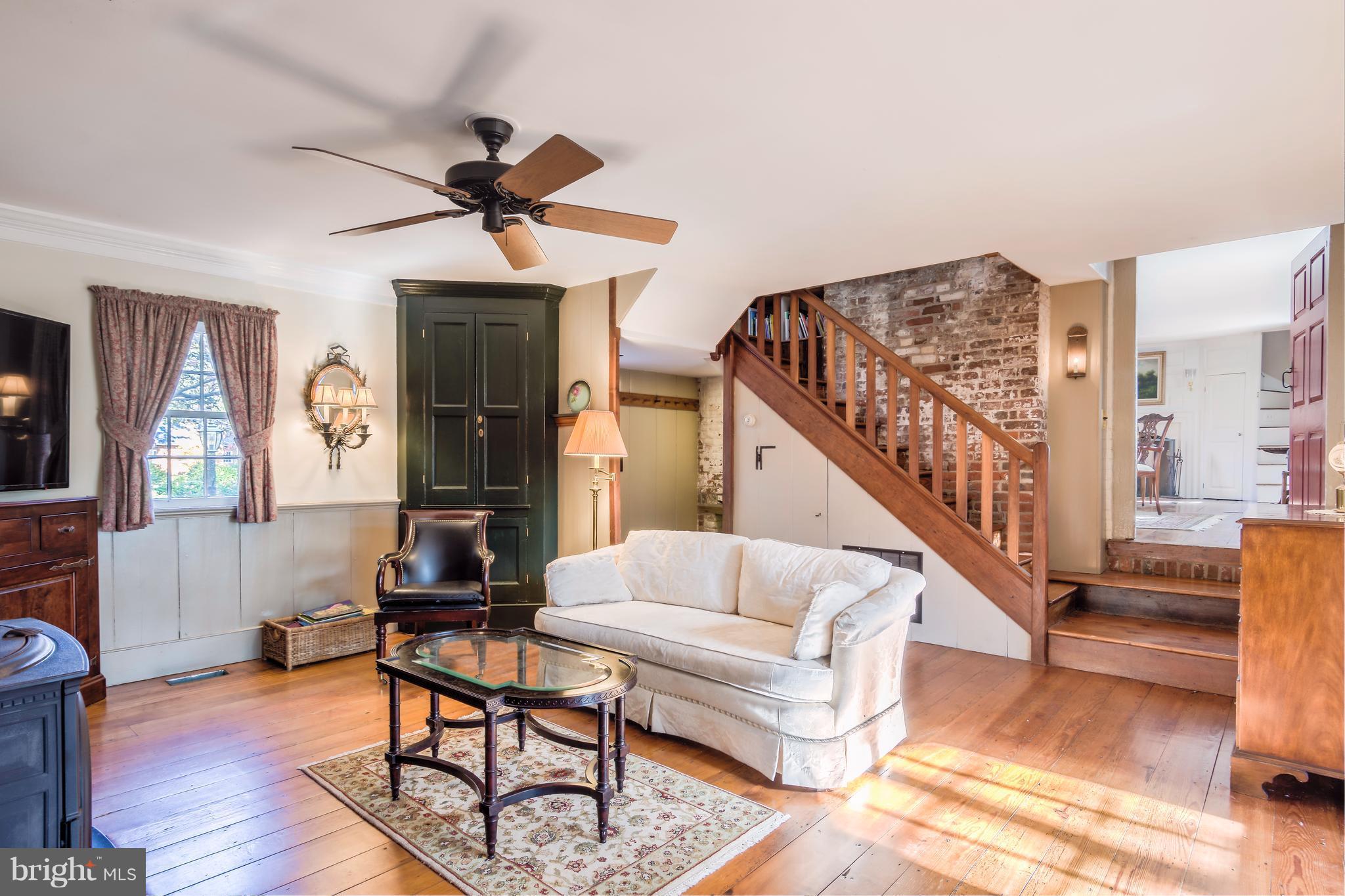 1625 Peters Corner Road Marydel, MD 21649 - Photo 9 of 30 a living room with fireplace furniture and a wooden floor