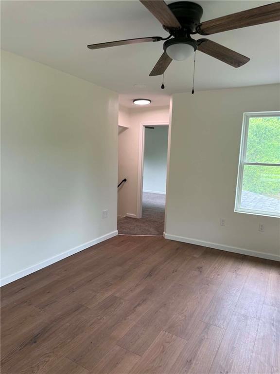 89 Old 51 Road Perryopolis, PA 15473 - Photo 11 of 45 an empty room with wooden floor fan and windows