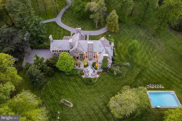an aerial view of a house with garden space sitting space and swimming pool