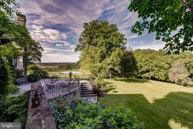 an aerial view of a house with garden space sitting space and swimming pool