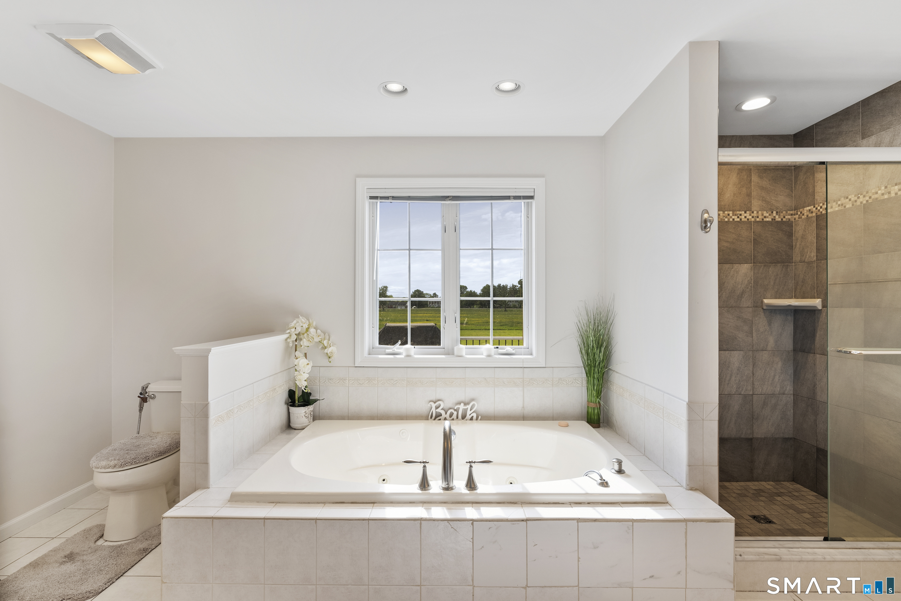 44 Farmstead Lane Suffield, CT 06078 - Photo 12 of 39 a bath tub sitting in a bathroom next to a toilet