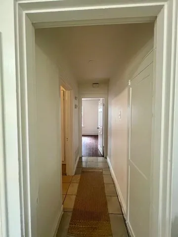 a large white bathroom with a double vanity sink mirror and a bathtub