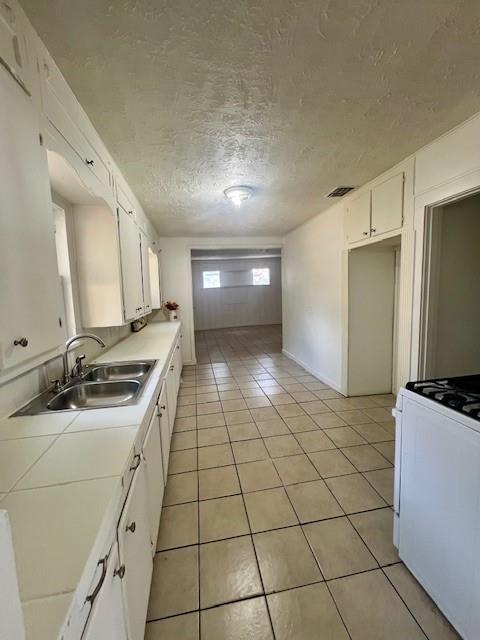 308 North Retta Street Fort Worth, TX 76111 - Photo 19 of 24 a kitchen with a sink a stove and a refrigerator