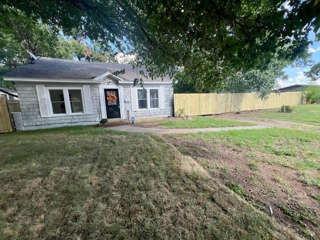 308 North Retta Street Fort Worth, TX 76111 - Photo 4 of 24 a front view of a house with a yard and trees