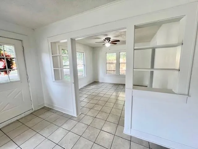 a view of a hallway with bathroom and a glass door