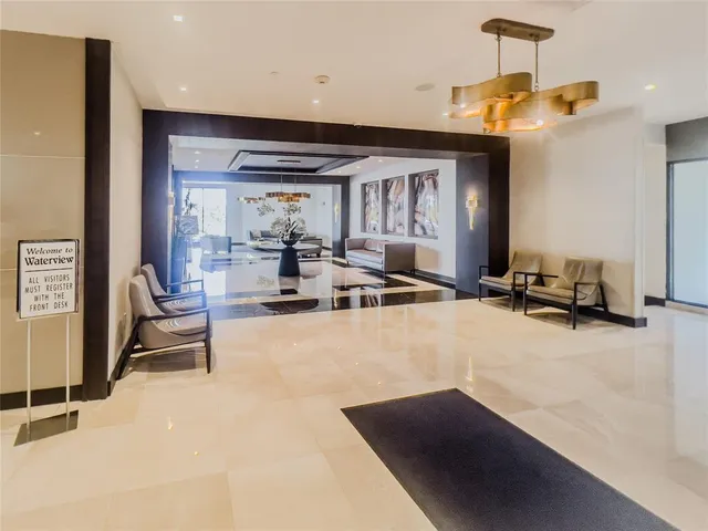 a living room with furniture and a chandelier