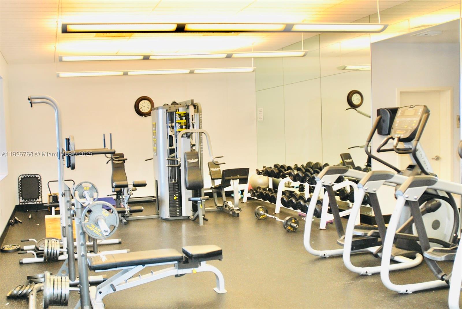 3232 Southwest 22nd Terrace, Unit 1008 Miami, FL 33145 - Photo 15 of 19 a view of a room with gym equipment