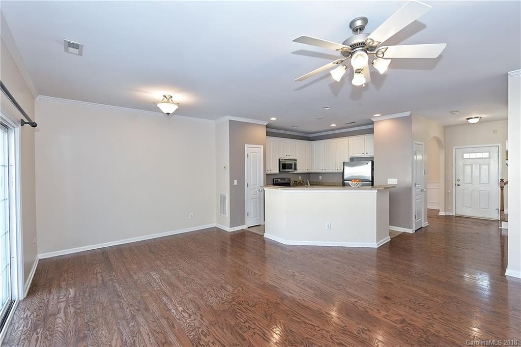 642 Brickdust Court Fort Mill, SC 29708 - Photo 9 of 24 a view of a kitchen with a refrigerator a microwave and a wooden floor