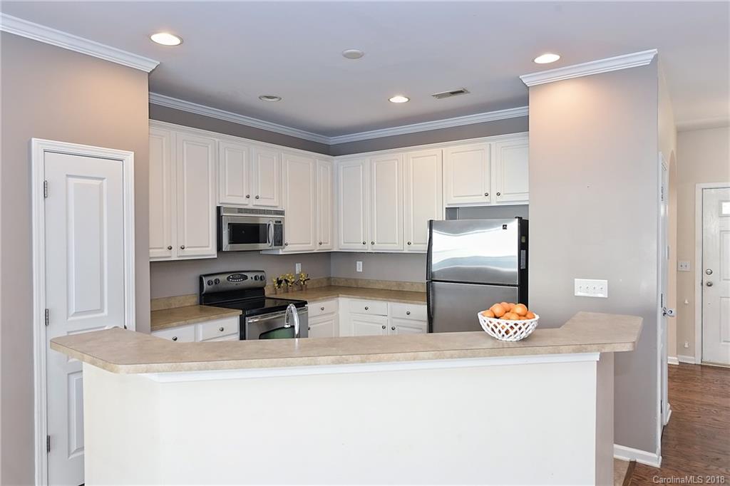 642 Brickdust Court Fort Mill, SC 29708 - Photo 10 of 24 a kitchen with granite countertop white cabinets and stainless steel appliances