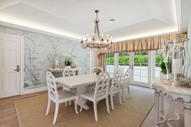 a view of a dining room with furniture wooden floor and chandelier