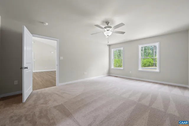 a bathroom with a granite countertop toilet sink and mirror