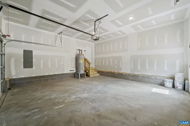 a front view of a house with a garden and trees