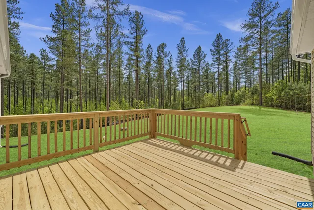 an aerial view of a residential houses with outdoor space and lake view