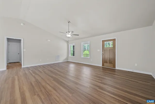 a view of a room with wooden floor and a window