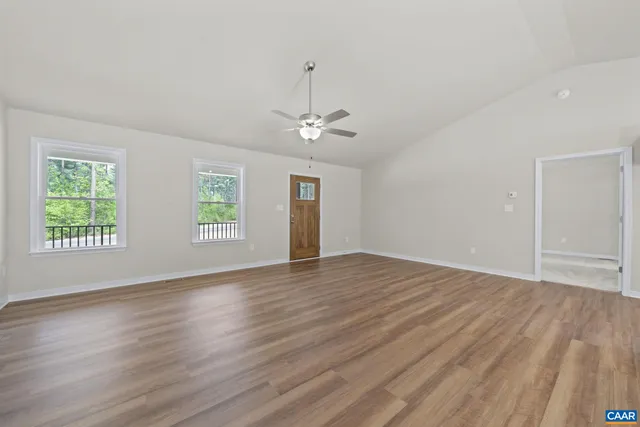 a view of a kitchen with wooden floor and a window
