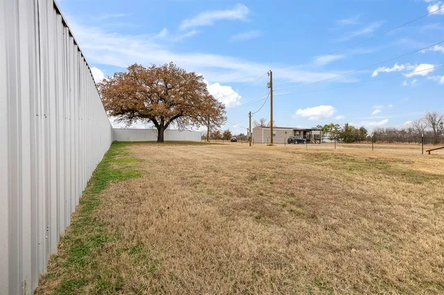 a view of a yard with a tree