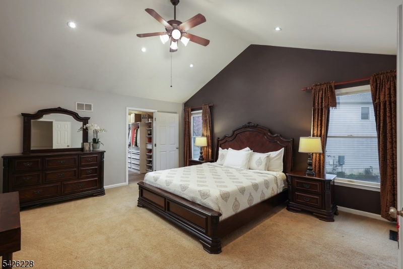 5 Gordon Place Bernards, NJ 07920 - Photo 12 of 30 a bedroom with a large bed and a chandelier