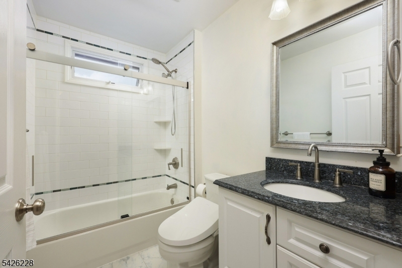 5 Gordon Place Bernards, NJ 07920 - Photo 18 of 30 a bathroom with a granite countertop sink toilet mirror and shower