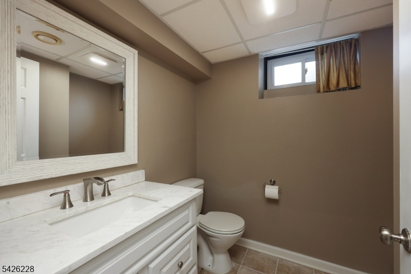 5 Gordon Place Bernards, NJ 07920 - Photo 24 of 30 a bathroom with a sink a toilet and mirror