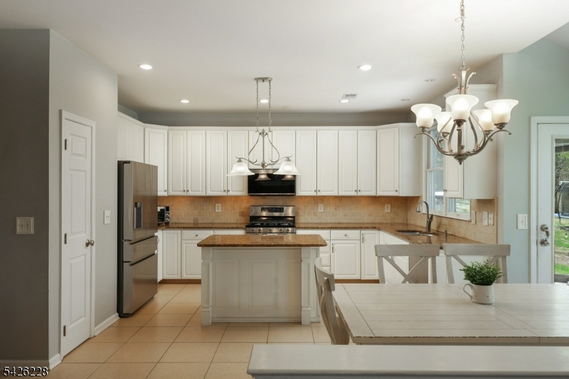 5 Gordon Place Bernards, NJ 07920 - Photo 9 of 30 a kitchen with stainless steel appliances granite countertop a sink a stove and a refrigerator