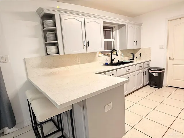 a kitchen with a sink appliances and cabinets