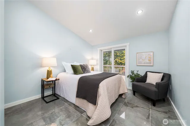 a spacious bedroom with a bed and a couch