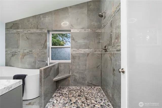 a bathroom with a bathtub and shower