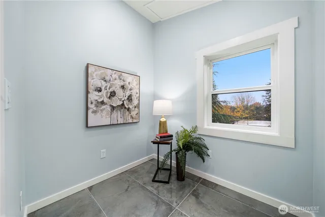 a view of a hallway with paintings on the wall