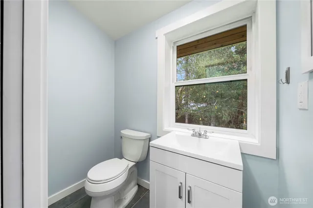a bathroom with a toilet sink and mirror