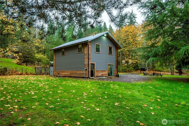 a backyard of a house with table and chairs