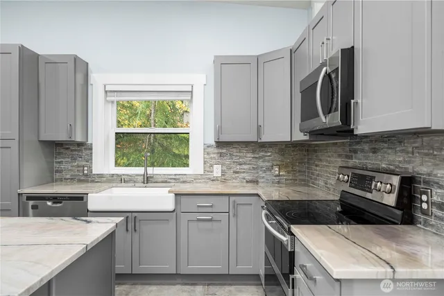 a kitchen with a sink stove and cabinets