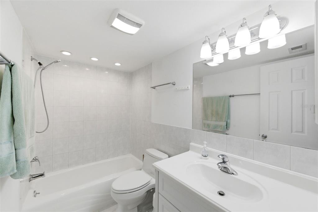 11485 Oakhurst Road, Unit 200208 Largo, FL 33774 - Photo 20 of 25 a bathroom with a sink a toilet and shower