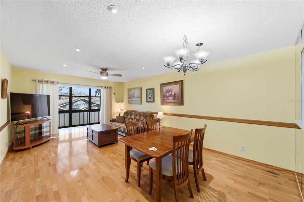 11485 Oakhurst Road, Unit 200208 Largo, FL 33774 - Photo 6 of 25 a living room with fireplace furniture and a flat screen tv