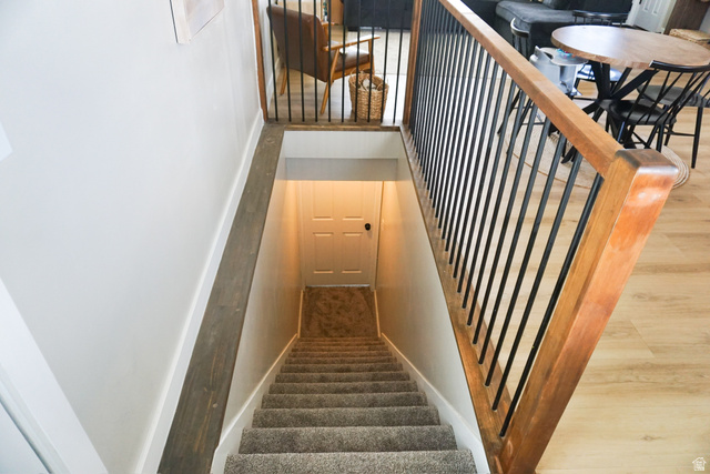 680 Timpie Road Tooele, UT 84074 - Photo 10 of 31 Staircase featuring wood-finish handrails and black metal balusters