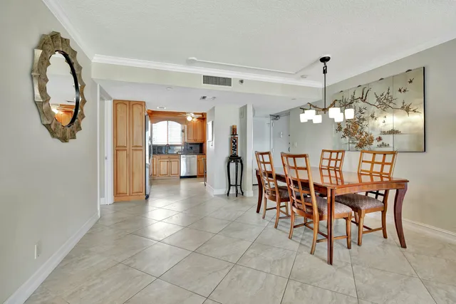a kitchen with granite countertop white cabinets stainless steel appliances a sink and a window